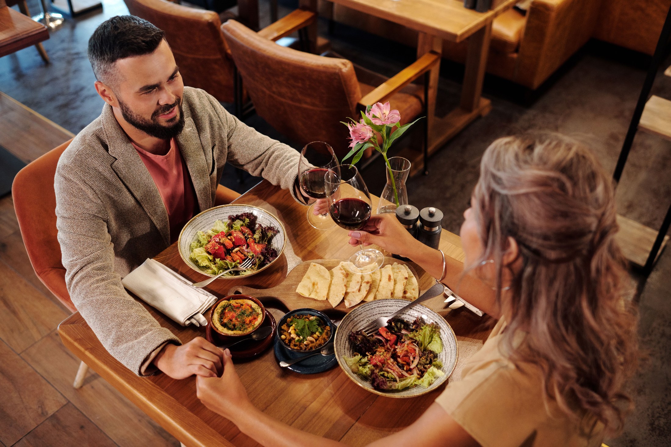 A couple sharing dinner in a warmly lit restaurant